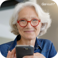 Older woman smiling, using her cell phone