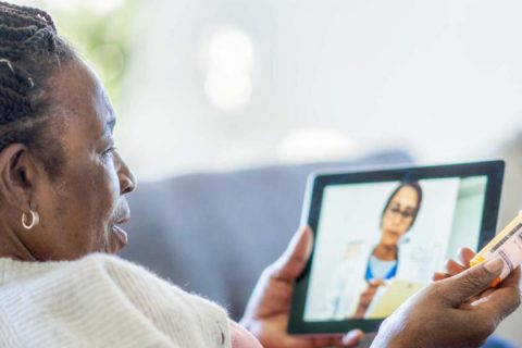 Older woman at home on a telehealth call on her tablet