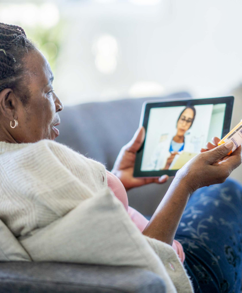 Older woman at home on a telehealth call on her tablet