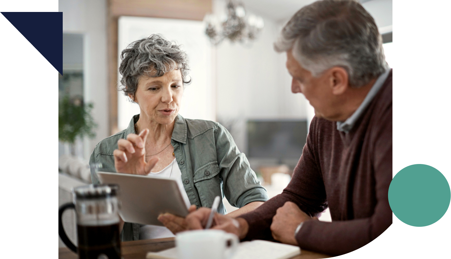 mature couple talking while using a digital tablet to learn about annuity riders