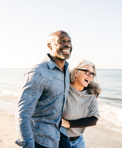 happy couple walking on beach