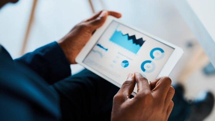 Man using investment app on tablet