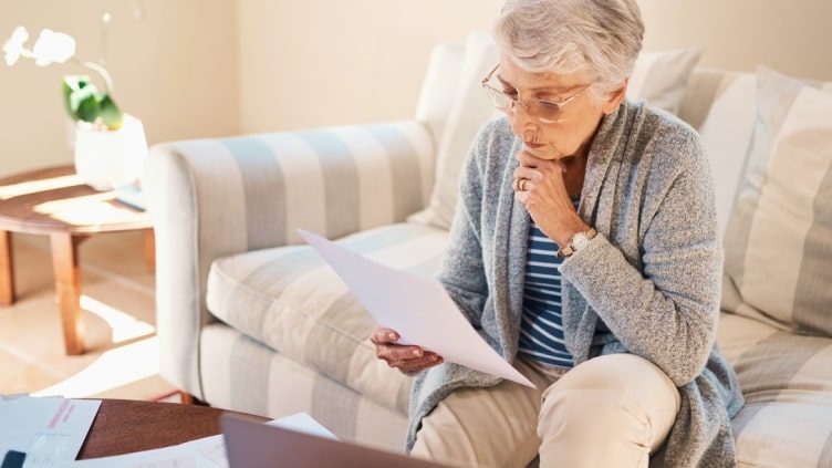 Older woman studying documents