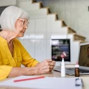 older woman using telehealth service and talking to doctor through laptop