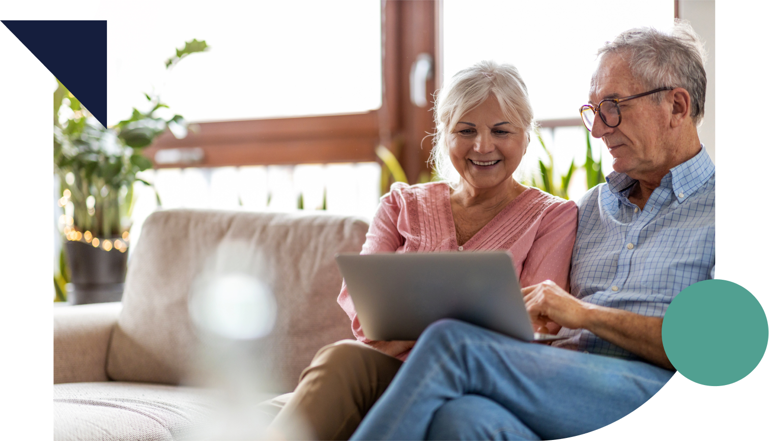 Mature couple using a laptop while relaxing at home