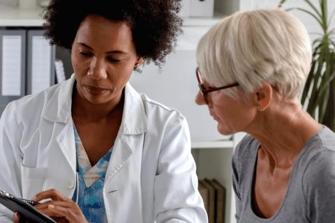 Female doctor with elderly patient