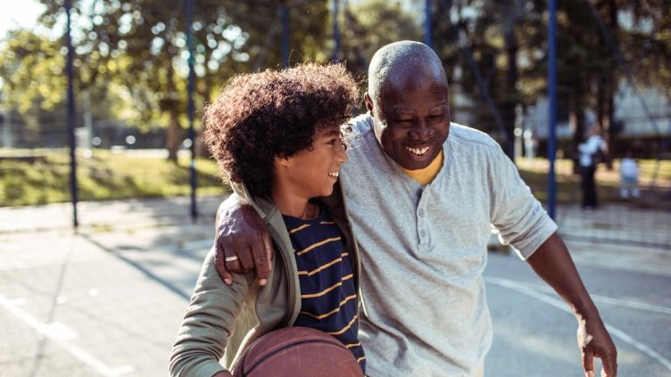 Grandfather playing basketball with grandson