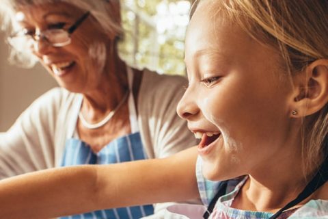 Grandmother and child cooking in kitchen
