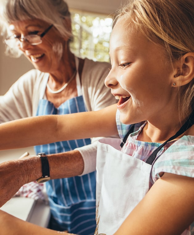 Grandmother and child cooking in kitchen
