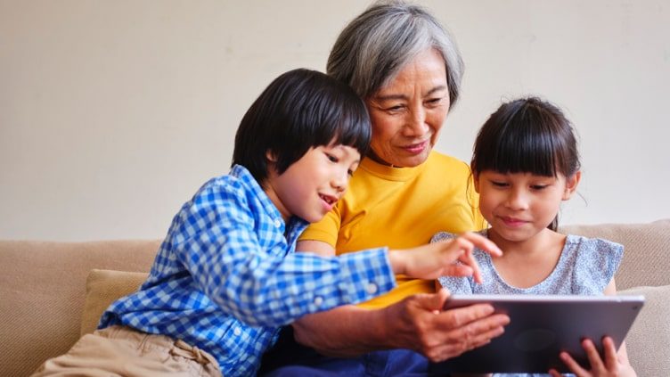 Grandmother reading to grandchildren