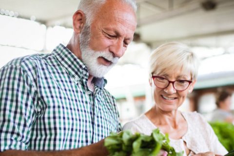 Elderly couple shopping at grocery store