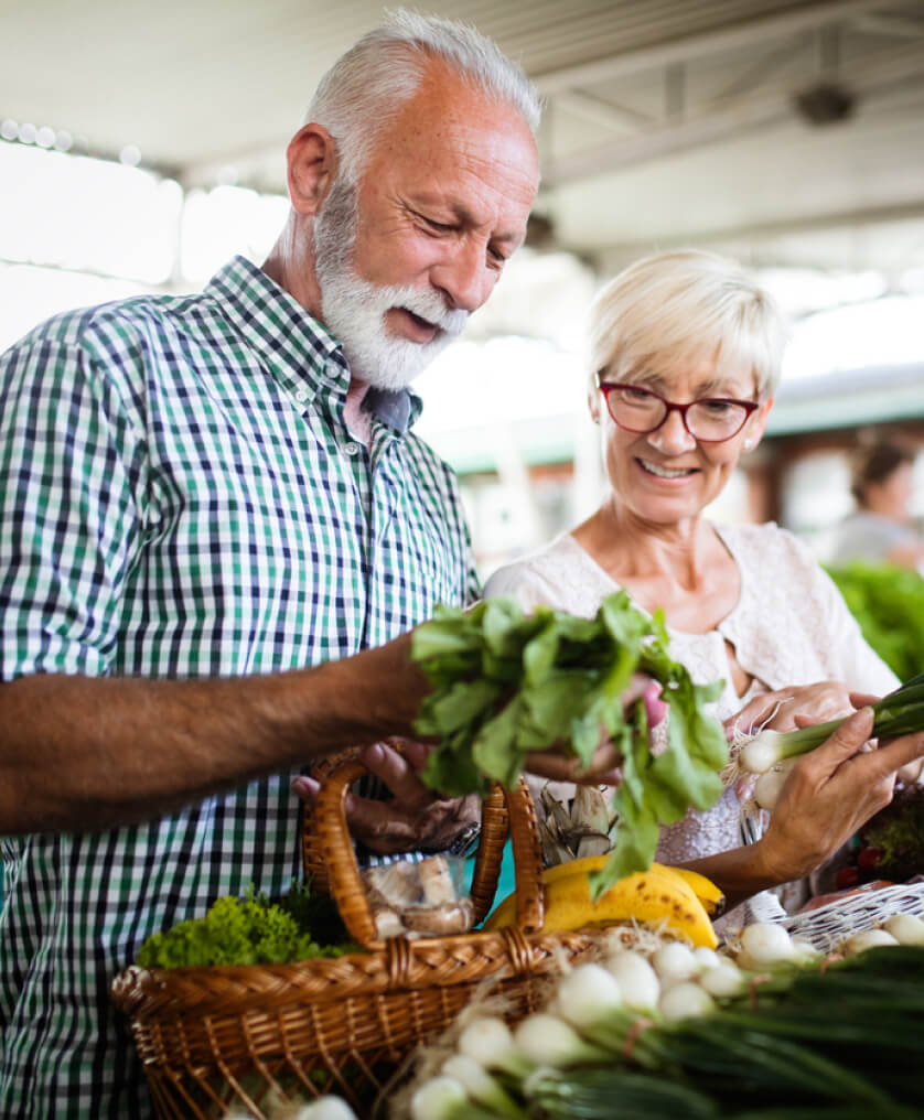 Elderly couple shopping at grocery store