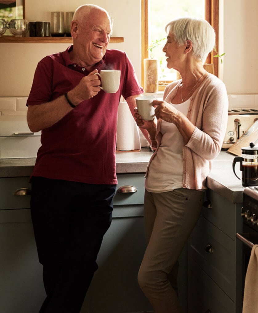 Elderly couple enjoying coffee in the kitchen together
