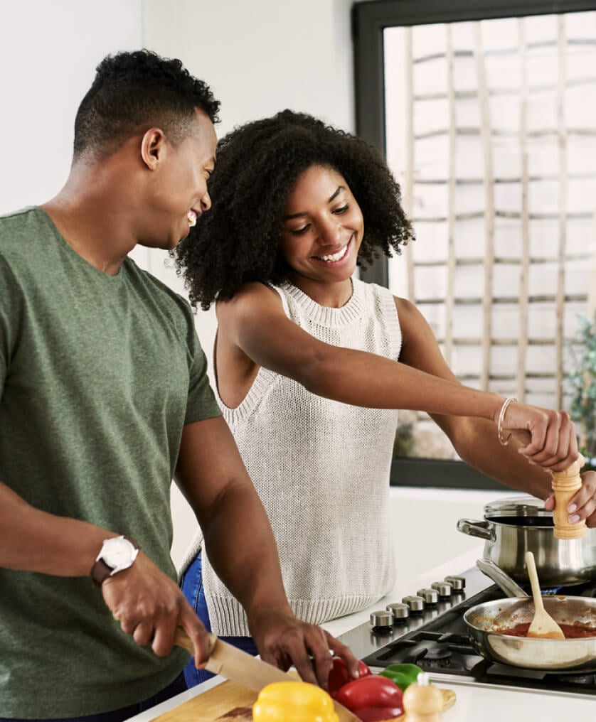 Young couple cooking together in kitchen