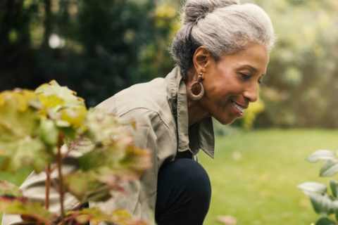 Elderly woman tending to her garden