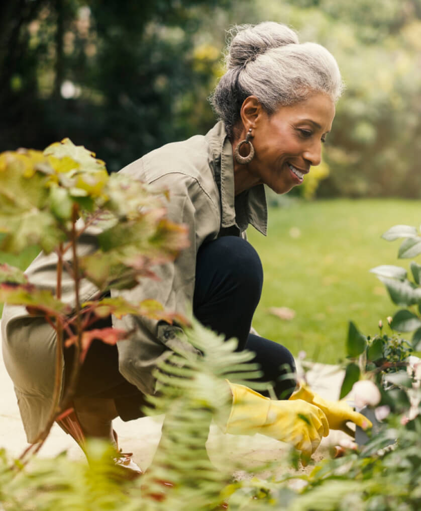 Elderly woman tending to her garden