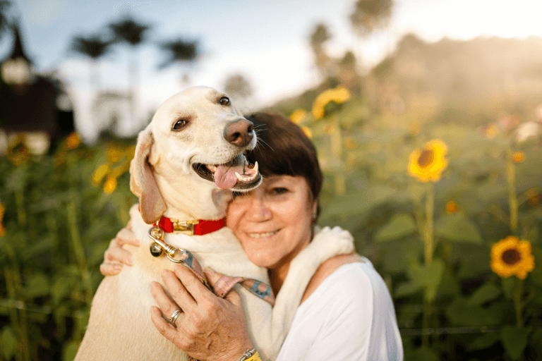 Senior woman hugging a dog