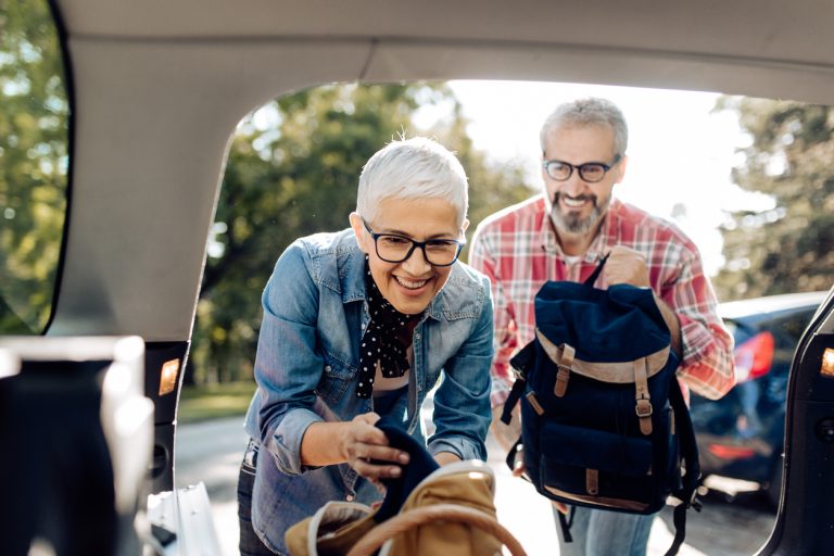 Senior couple packing for a road trip