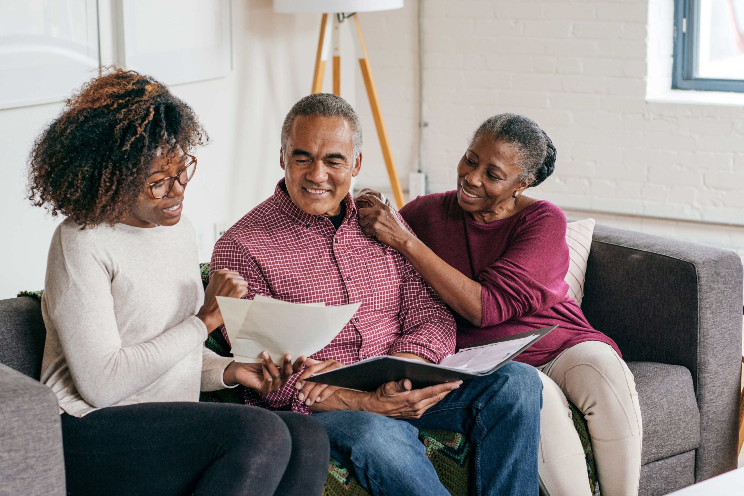 Older couple discussing over papers with adult