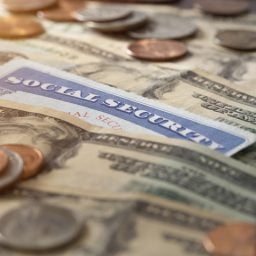 Social Security card sitting on top of money