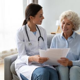 Doctor reviews paperwork with senior patient