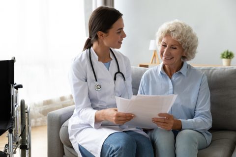 Doctor reviews paperwork with senior patient