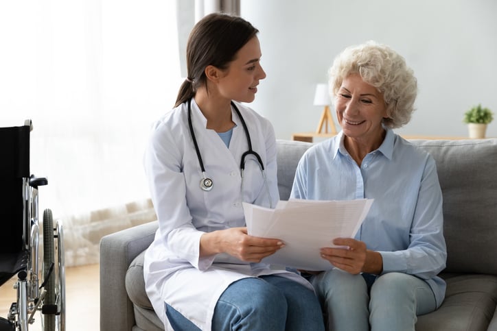 Doctor reviews paperwork with senior patient