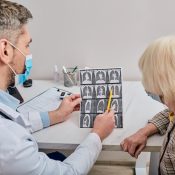 Doctor Shows Patient CT Scan Of Lungs