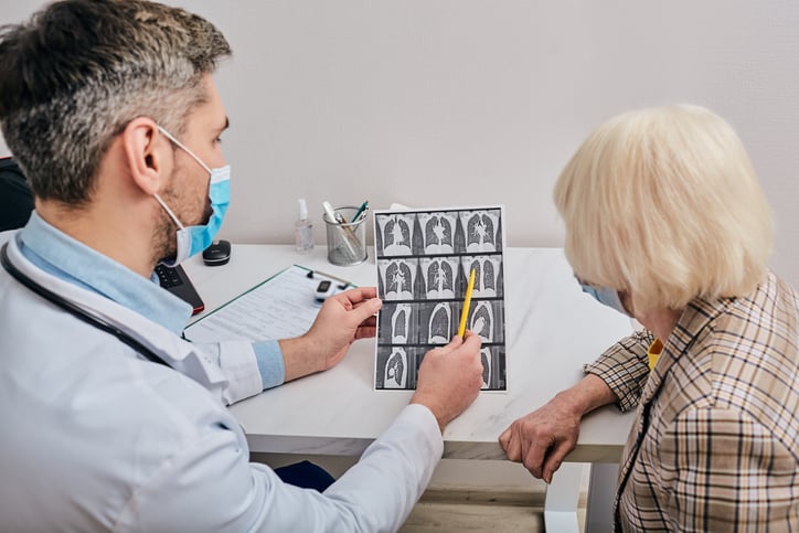 Doctor Shows Patient CT Scan Of Lungs