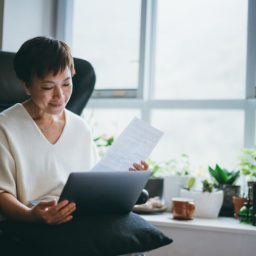 Women looking at information on paper and laptop