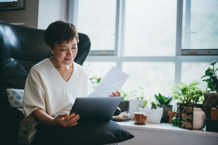 Women looking at information on paper and laptop