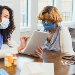 Nurse talks with patient about medications