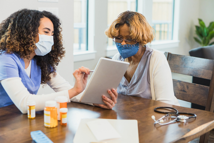 Nurse talks with patient about medications