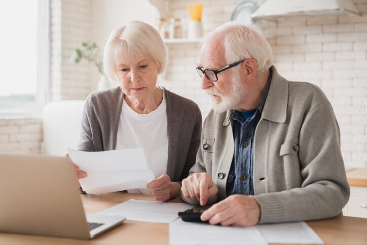 Older couple look at their bills