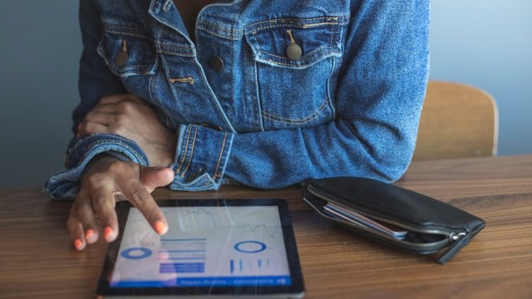 Woman using financial app on tablet