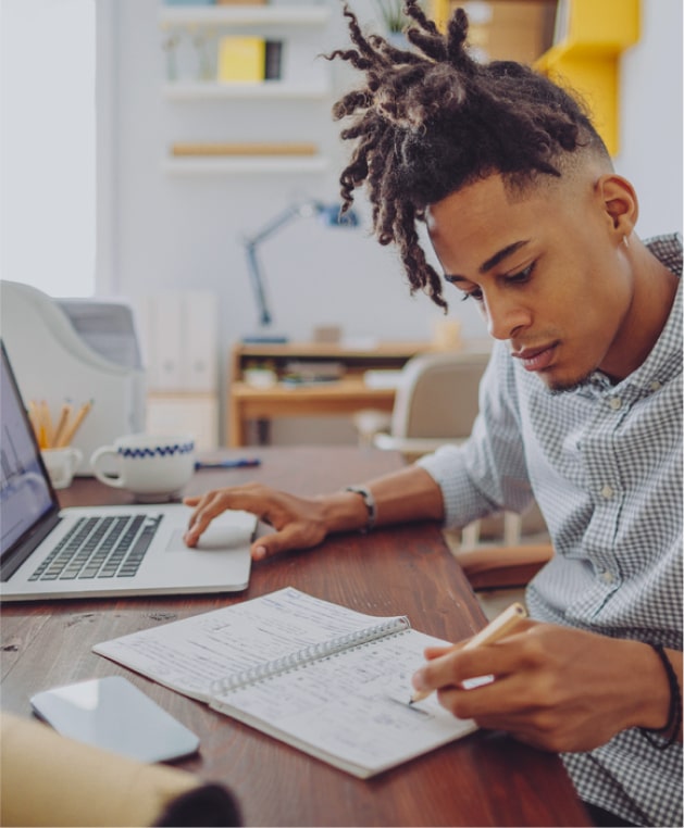 Young man taking notes