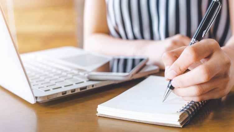 Young woman taking notes