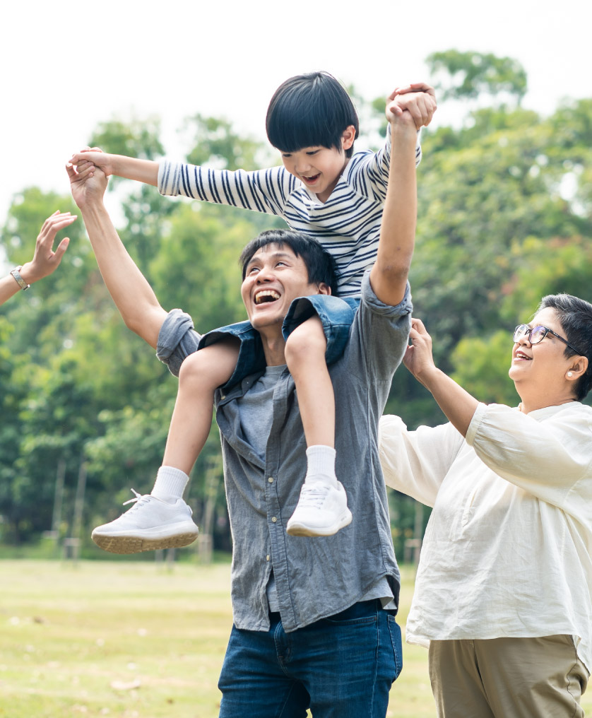 Child on man's shoulders with senior woman