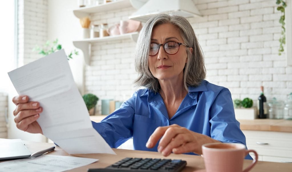 Senior woman using a calculator