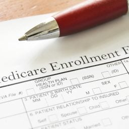 Medicare Enrollment Form and a red pen