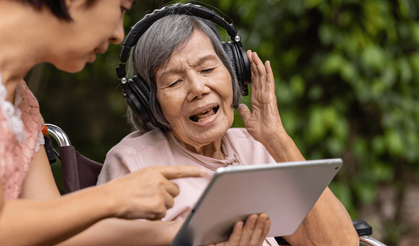 Older woman listening to music through headphones.