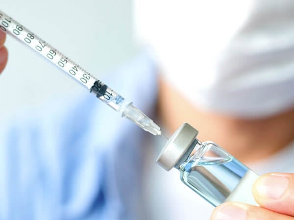 Needle removing insulin from vial