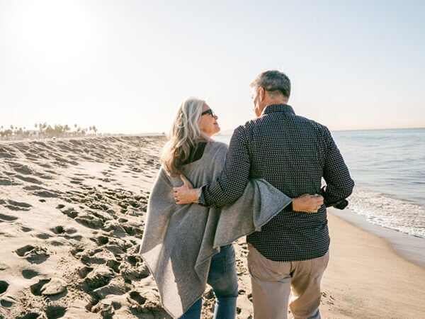 Older couple walking along the beach