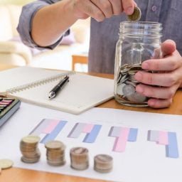 Older man saving coins in a jar