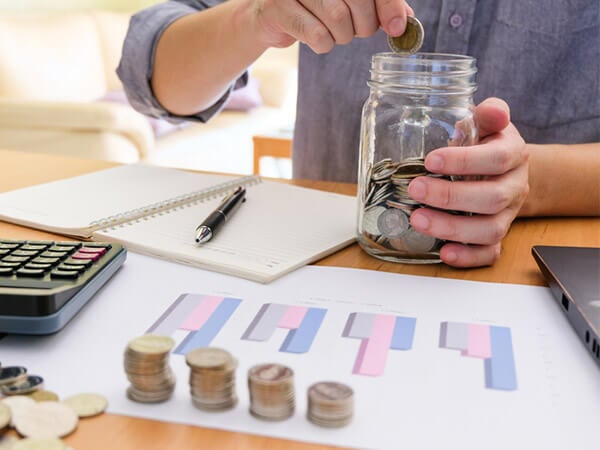 Older man saving coins in a jar