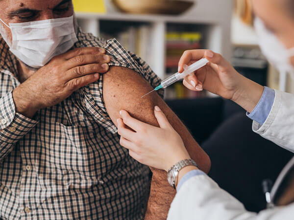 Older man receiving the Covid-19 vaccine