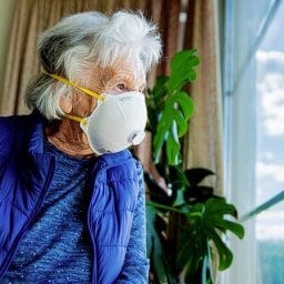 Older woman looking out of the window