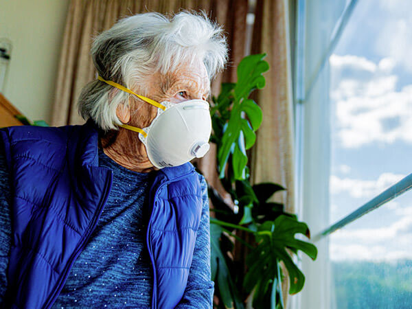 Older woman looking out of the window