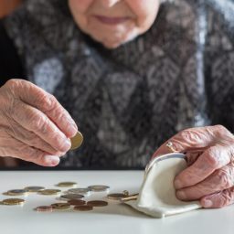 older woman counting coins