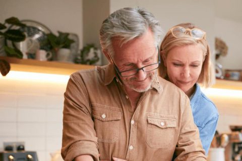 Older couple signing life insurance contract